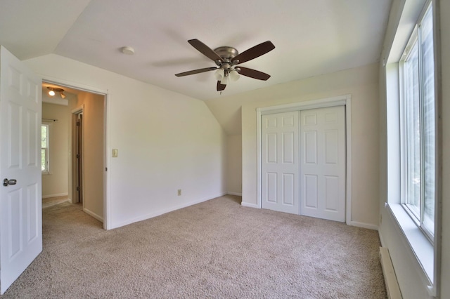 809 7th St, Brainerd, MN 56401 - unfurnished bedroom featuring light carpet, a closet, a baseboard radiator, and lofted ceiling