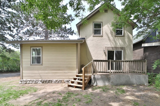 809 7th St, Brainerd, MN 56401 - back of house featuring stucco siding and a wooden deck