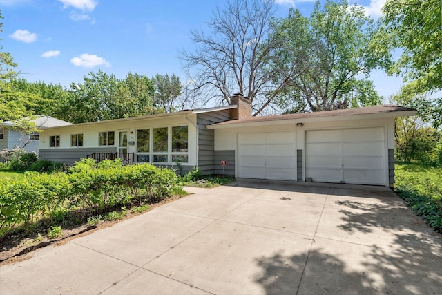 6300 Brooklyn Dr, Brooklyn Center, MN 55430 - view of front of property featuring a chimney, driveway, and a garage