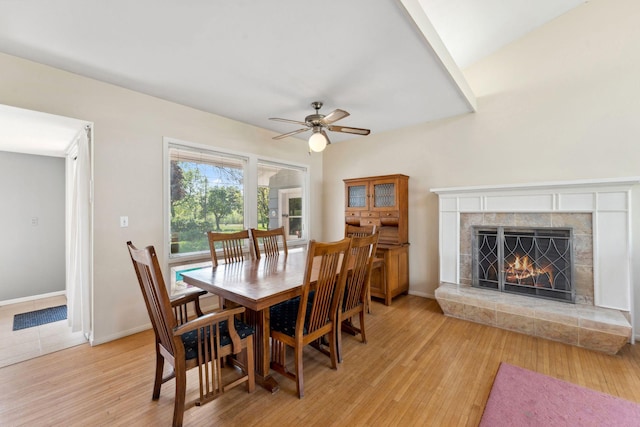 6300 Brooklyn Dr, Brooklyn Center, MN 55430 - dining area featuring light wood-style flooring, a ceiling fan, a premium fireplace, and baseboards