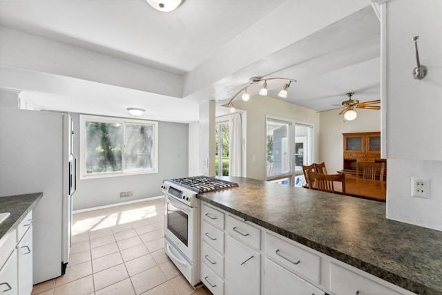 6300 Brooklyn Dr, Brooklyn Center, MN 55430 - kitchen featuring white appliances, dark countertops, white cabinetry, and ceiling fan