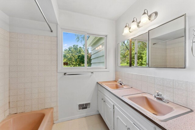 6300 Brooklyn Dr, Brooklyn Center, MN 55430 - bathroom featuring plenty of natural light, backsplash, tub / shower combination, and double vanity