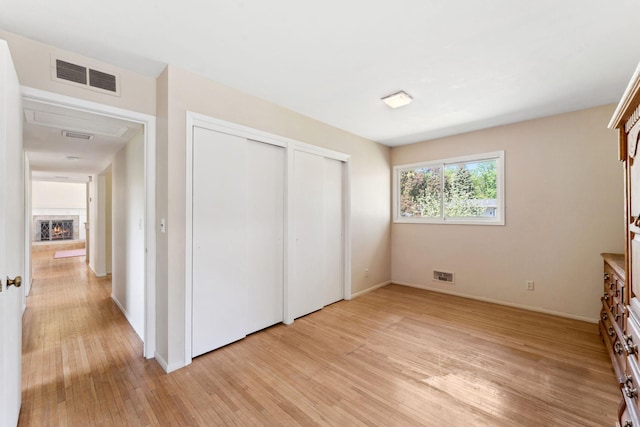 6300 Brooklyn Dr, Brooklyn Center, MN 55430 - unfurnished bedroom featuring light wood-style flooring, baseboards, and a closet