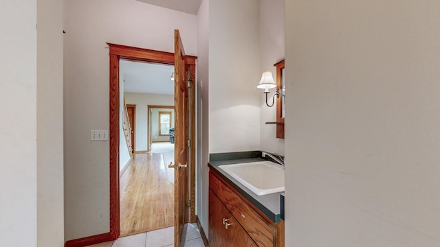 bathroom featuring vanity, tile patterned floors, and baseboards