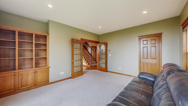living room with baseboards, light carpet, stairway, and recessed lighting