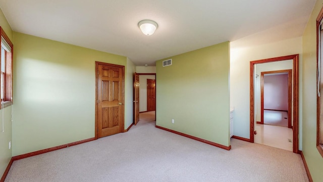 spare room with carpet and baseboards
