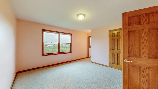 unfurnished bedroom with carpet flooring and baseboards