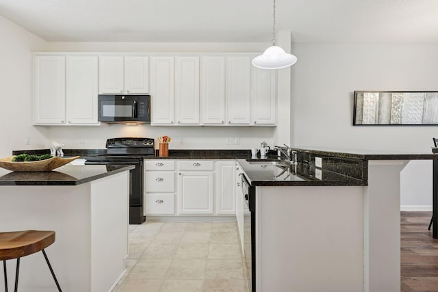 9675 Toledo Ln N, Brooklyn Park, MN 55443 - kitchen featuring black appliances, a peninsula, a kitchen breakfast bar, a sink, and white cabinetry