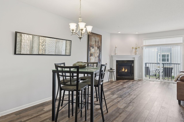 9675 Toledo Ln N, Brooklyn Park, MN 55443 - dining space featuring dark wood-style flooring, a chandelier, baseboards, a warm lit fireplace, and recessed lighting