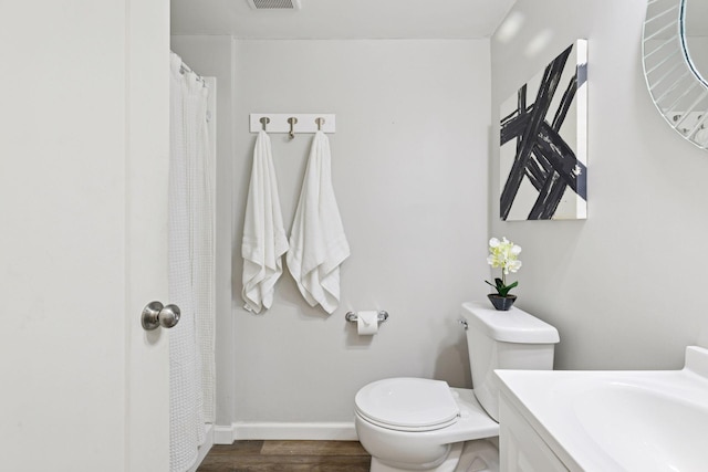 9675 Toledo Ln N, Brooklyn Park, MN 55443 - bathroom with toilet, vanity, baseboards, and wood finished floors