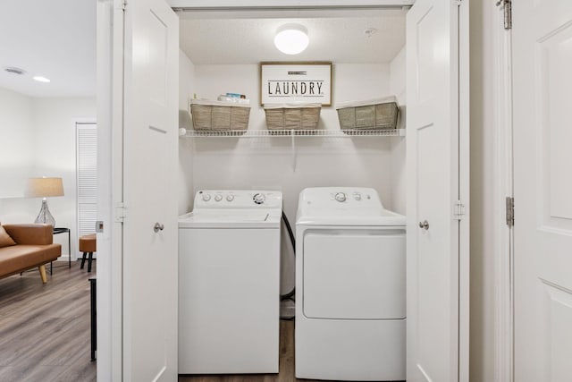 9675 Toledo Ln N, Brooklyn Park, MN 55443 - washroom with washer and clothes dryer, wood finished floors, and a textured ceiling