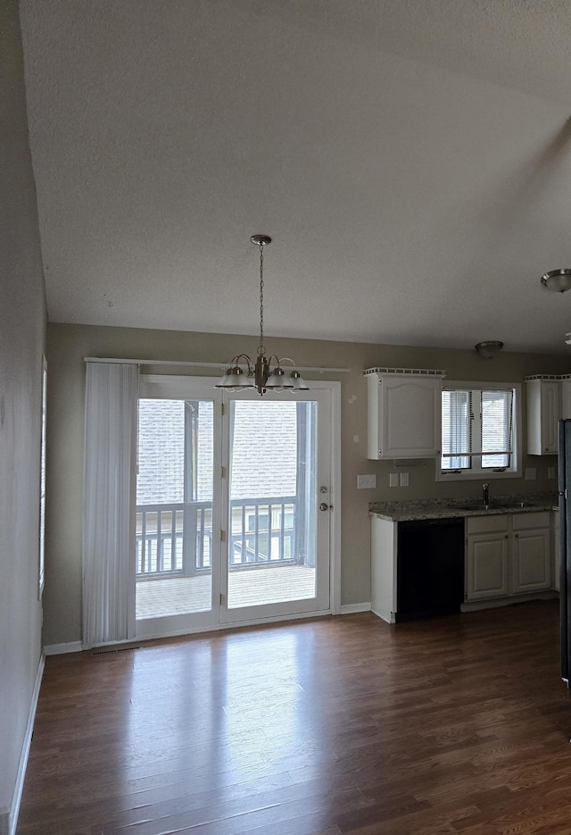 403 Littleford Ln, Faribault, MN 55021 - kitchen with a chandelier, dark wood-style floors, white cabinetry, and baseboards