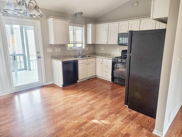 403 Littleford Ln, Faribault, MN 55021 - kitchen featuring black appliances, lofted ceiling, light wood-style flooring, and white cabinetry