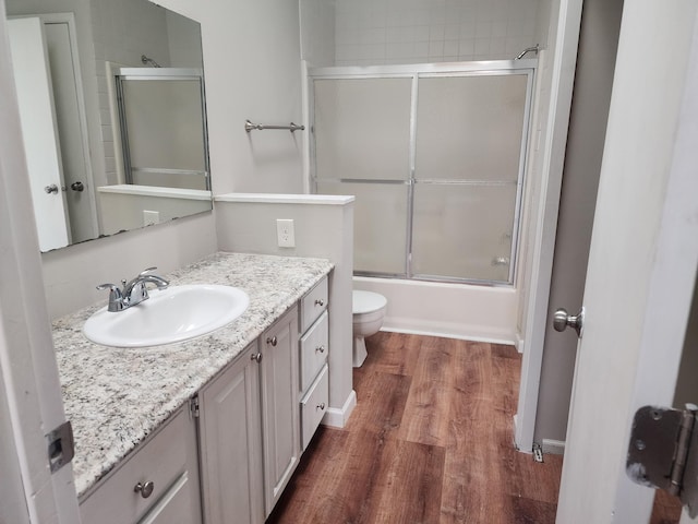 403 Littleford Ln, Faribault, MN 55021 - full bath with toilet, wood finished floors, vanity, and enclosed tub / shower combo