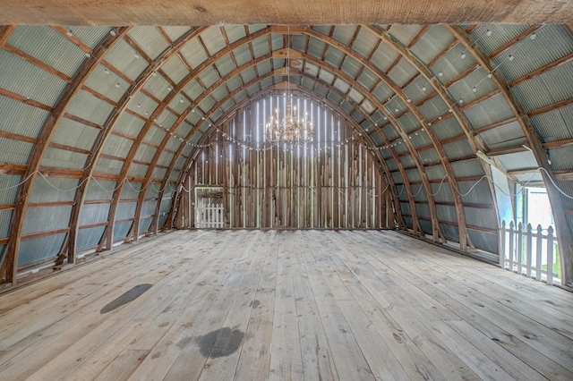 8632 Neal Ave S, Denmark Twp, MN 55033 - miscellaneous room featuring vaulted ceiling, hardwood / wood-style flooring, and a chandelier