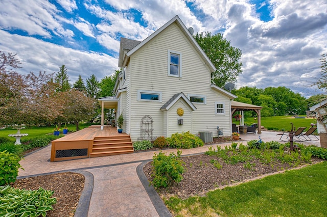 8632 Neal Ave S, Denmark Twp, MN 55033 - view of side of property with a patio, a lawn, cooling unit, and a deck