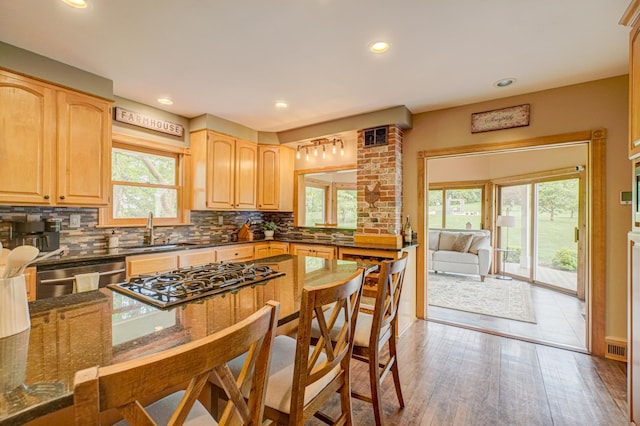 8632 Neal Ave S, Denmark Twp, MN 55033 - kitchen featuring dishwasher, a sink, gas cooktop, tasteful backsplash, and light brown cabinets