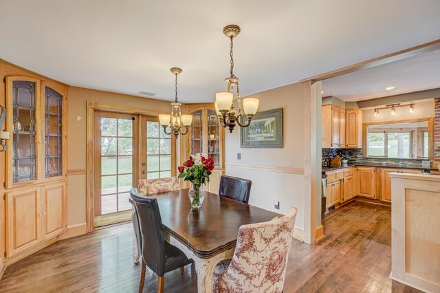 8632 Neal Ave S, Denmark Twp, MN 55033 - dining area featuring a chandelier, plenty of natural light, and wood finished floors