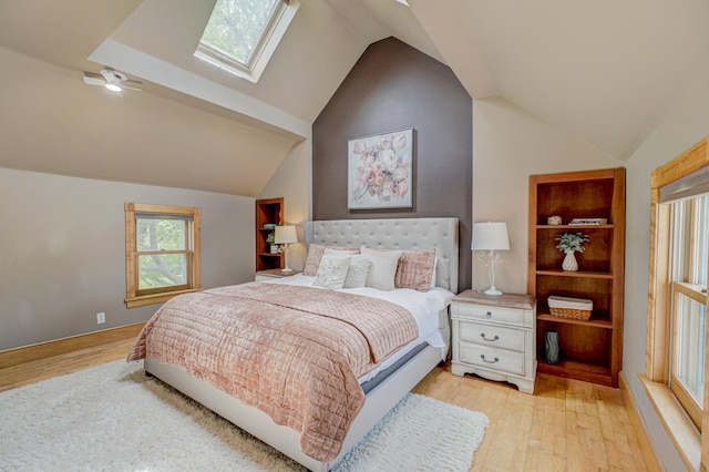 8632 Neal Ave S, Denmark Twp, MN 55033 - bedroom with multiple windows, light wood-type flooring, lofted ceiling, and a skylight