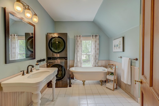 8632 Neal Ave S, Denmark Twp, MN 55033 - bathroom with estacked washer and dryer, healthy amount of natural light, a wainscoted wall, a freestanding bath, and tile patterned flooring