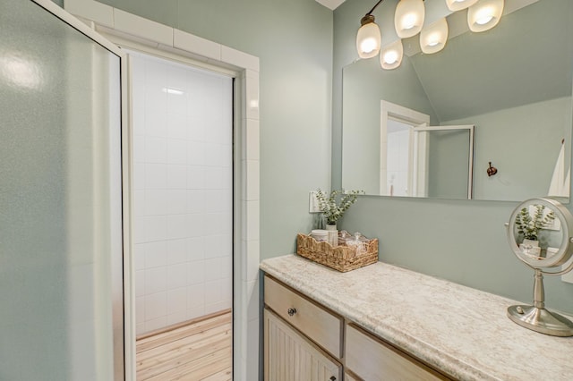 8632 Neal Ave S, Denmark Twp, MN 55033 - bathroom featuring a stall shower, vanity, and lofted ceiling