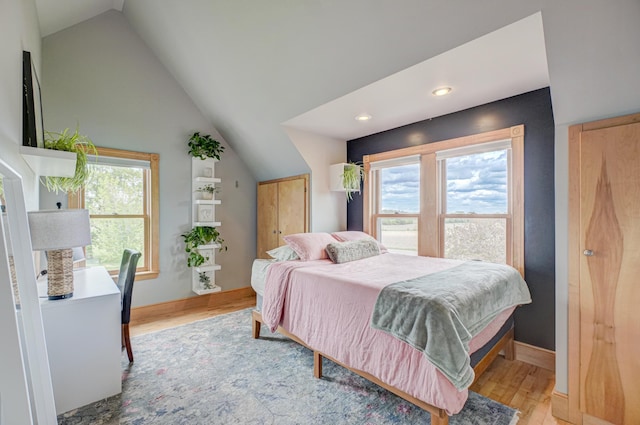8632 Neal Ave S, Denmark Twp, MN 55033 - bedroom featuring light wood-style flooring, vaulted ceiling, baseboards, and recessed lighting
