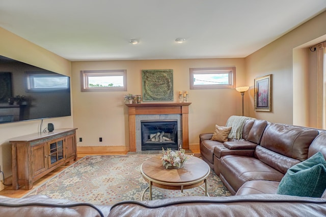 8632 Neal Ave S, Denmark Twp, MN 55033 - living room with plenty of natural light, a tile fireplace, wood finished floors, and baseboards