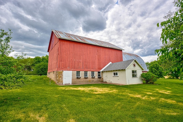 8632 Neal Ave S, Denmark Twp, MN 55033 - rear view of property with a lawn, metal roof, and an outdoor structure