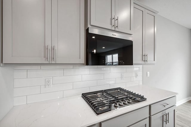 8397 Brumby Trl, Woodbury, MN 55129 - kitchen with stainless steel gas cooktop, backsplash, and gray cabinetry