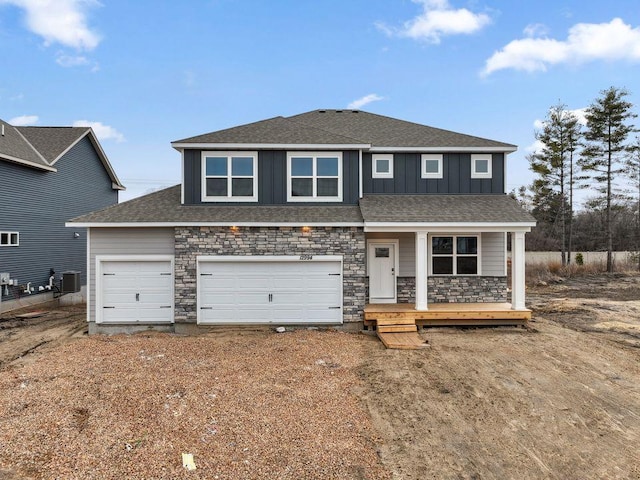 8397 Brumby Trl, Woodbury, MN 55129 - view of front of property with covered porch, board and batten siding, stone siding, central AC, and roof with shingles