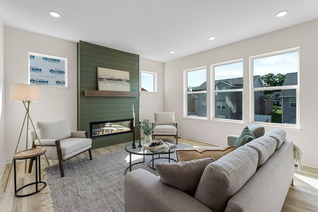 13430 Cadogan Way, Rosemount, MN 55068 - living area with a fireplace, light wood-style floors, recessed lighting, and baseboards