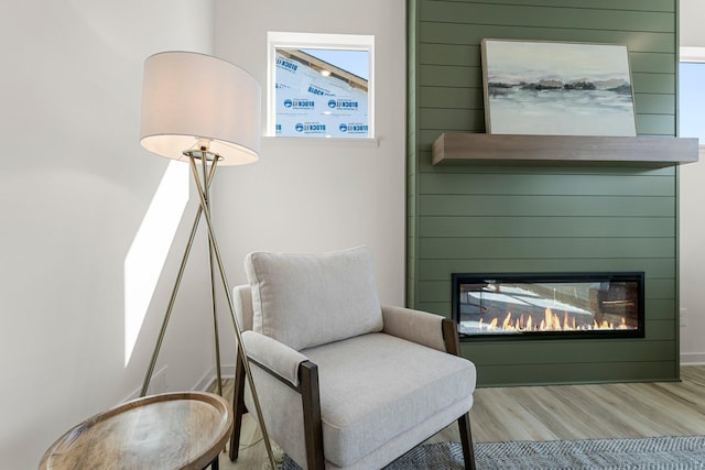 13430 Cadogan Way, Rosemount, MN 55068 - sitting room featuring wood finished floors and a glass covered fireplace