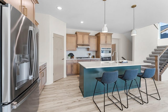 13430 Cadogan Way, Rosemount, MN 55068 - kitchen featuring stainless steel appliances, light wood finished floors, light countertops, tasteful backsplash, and recessed lighting