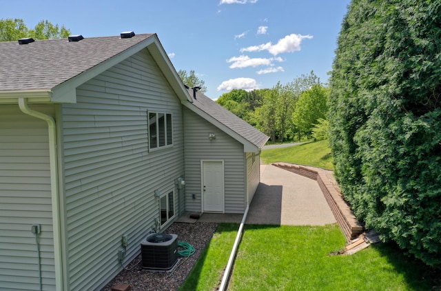8790 212th St N, Forest Lake, MN 55025 - view of property exterior featuring central air condition unit, roof with shingles, and a yard