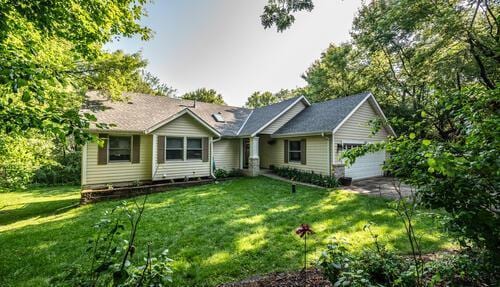 2211 Douglynn Ln, Saint Paul, MN 55119 - view of front of home featuring an attached garage and a front lawn