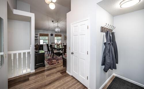 2211 Douglynn Ln, Saint Paul, MN 55119 - hall with wood finished floors, a chandelier, and baseboards