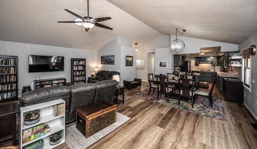 2211 Douglynn Ln, Saint Paul, MN 55119 - living room featuring lofted ceiling, wood finished floors, a ceiling fan, and a chandelier