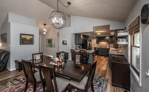 2211 Douglynn Ln, Saint Paul, MN 55119 - dining area with vaulted ceiling, dark wood finished floors, and a chandelier