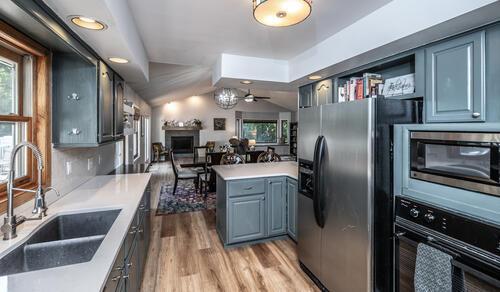 2211 Douglynn Ln, Saint Paul, MN 55119 - kitchen with appliances with stainless steel finishes, a sink, plenty of natural light, and light wood-style floors