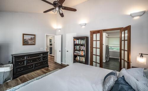 2211 Douglynn Ln, Saint Paul, MN 55119 - bedroom with french doors, wood finished floors, high vaulted ceiling, and baseboards