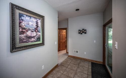 2211 Douglynn Ln, Saint Paul, MN 55119 - corridor with tile patterned flooring, a textured ceiling, and baseboards