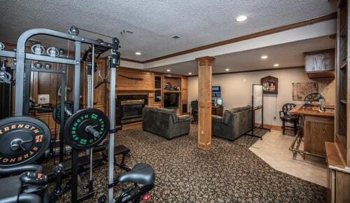 2211 Douglynn Ln, Saint Paul, MN 55119 - exercise room with ornamental molding, decorative columns, a textured ceiling, a fireplace, and recessed lighting