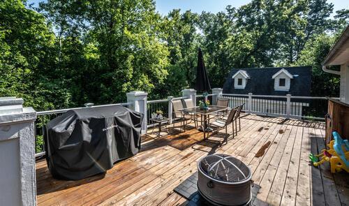 2211 Douglynn Ln, Saint Paul, MN 55119 - wooden deck with outdoor dining space and view of scattered trees