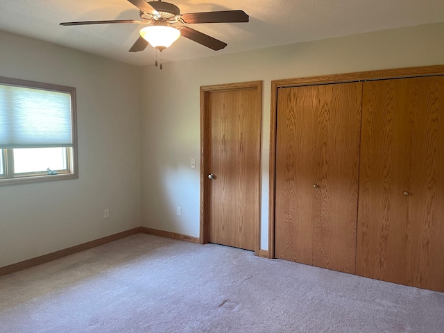 22 Jayvee Ln, Lake Sarah Twp, MN 56132 - unfurnished bedroom with carpet, two closets, and ceiling fan
