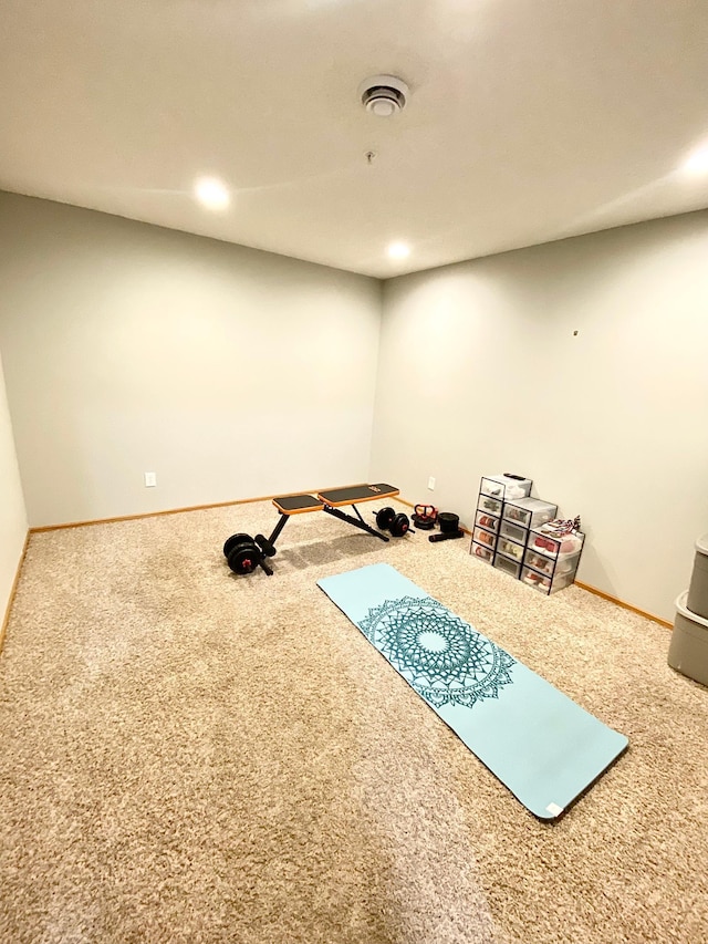 exercise room with carpet and baseboards