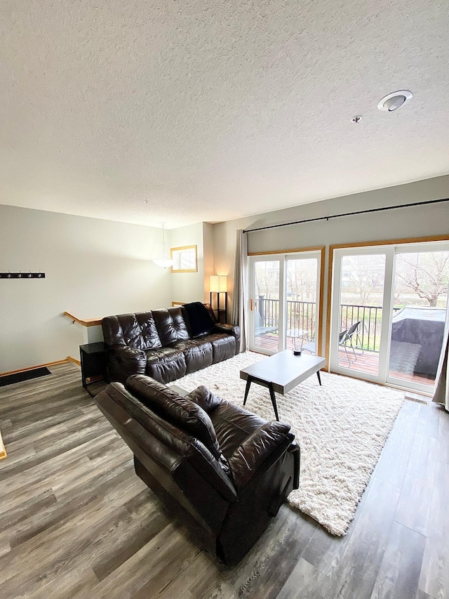 living area with wood finished floors and a textured ceiling