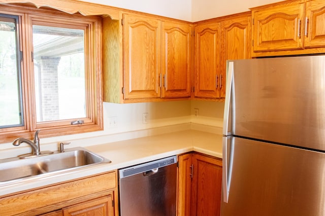 32682 S Bay Ln, Breezy Point, MN 56472 - kitchen featuring stainless steel appliances, a sink, light countertops, and brown cabinetry