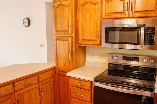 32682 S Bay Ln, Breezy Point, MN 56472 - kitchen with stainless steel appliances, light countertops, and brown cabinets