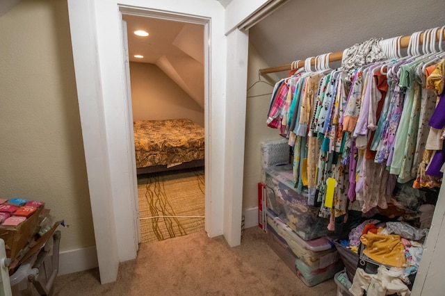 spacious closet featuring carpet floors and vaulted ceiling