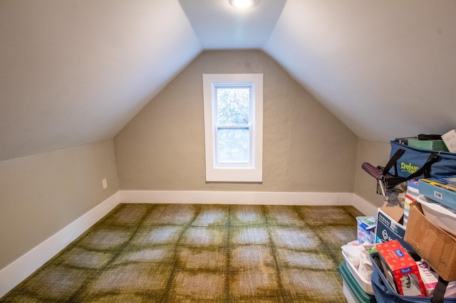 additional living space with vaulted ceiling, carpet floors, and baseboards